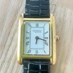 Caravelle by Bulova ladies rectangular gold tone black leather watch